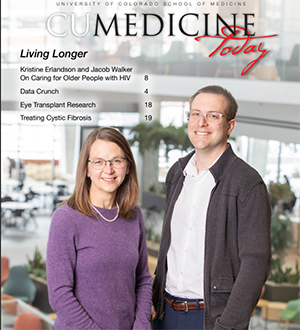 Kristine Erlandson, MD,  and Jacob Walker, MD standing in an atrium
