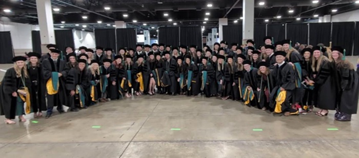 Photo of the Class of 2024 in regalia gathered at commencement.